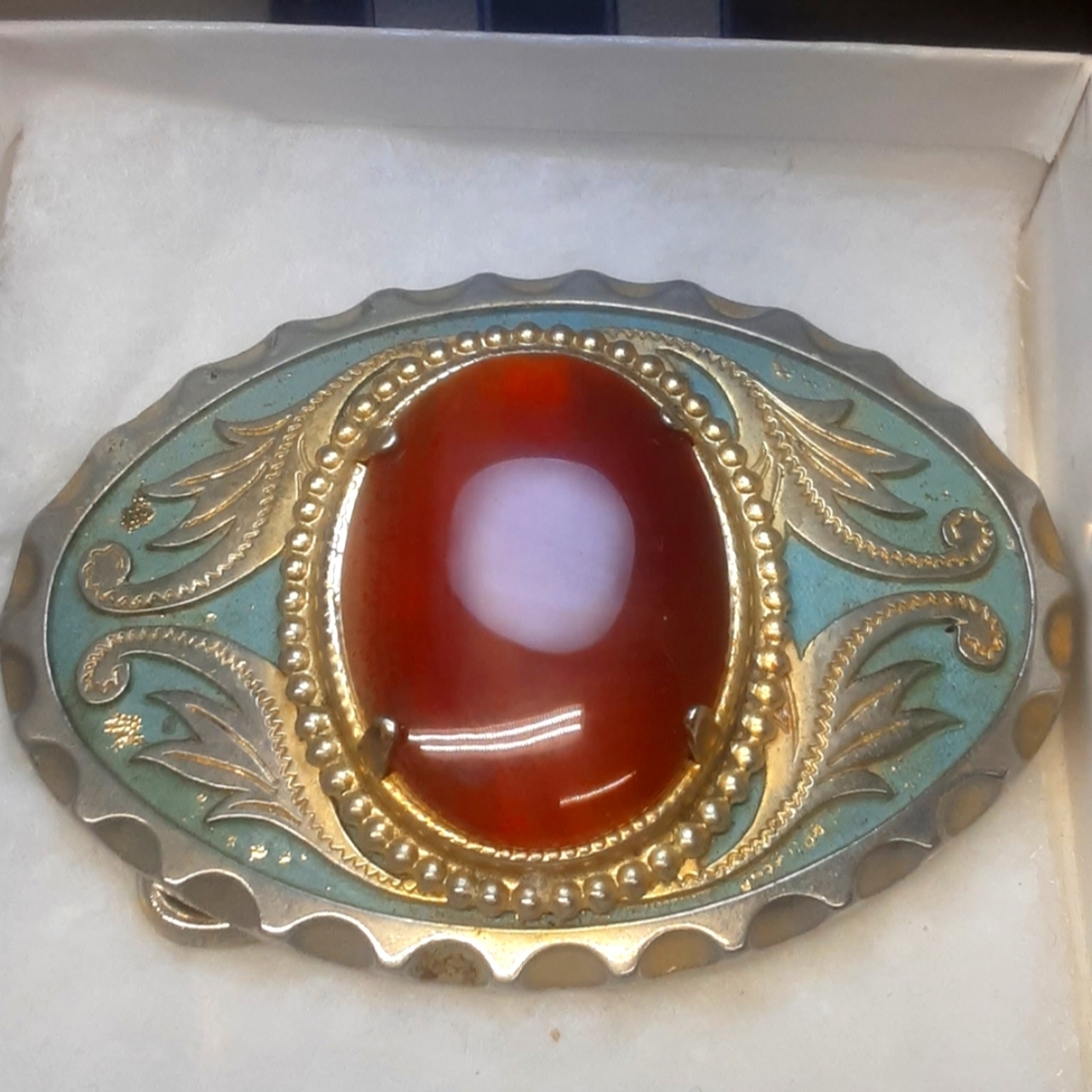 Belt buckle, fancy with real amber stone in the center.